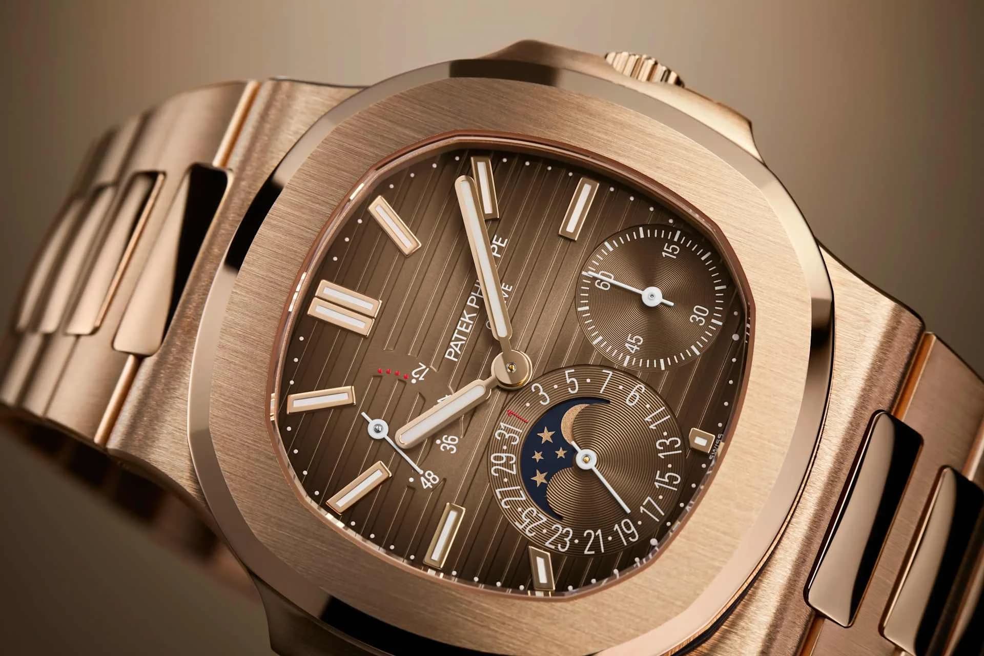 reloj de caja dorada con esfera marrón texturizada, subesfera de segundos y fase lunar con fecha