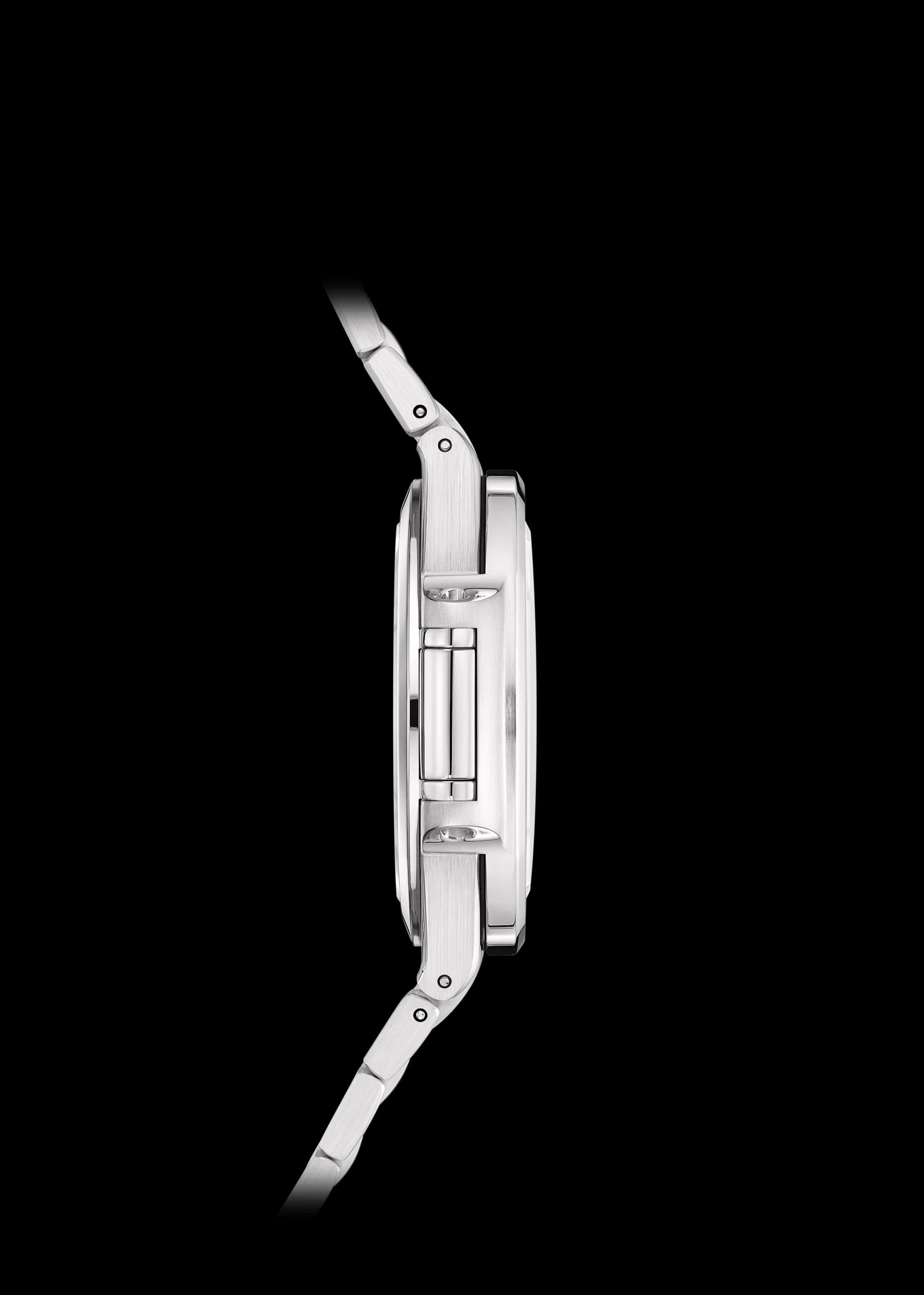 vista de perfil de un reloj de acero con brazalete integrado y corona lateral